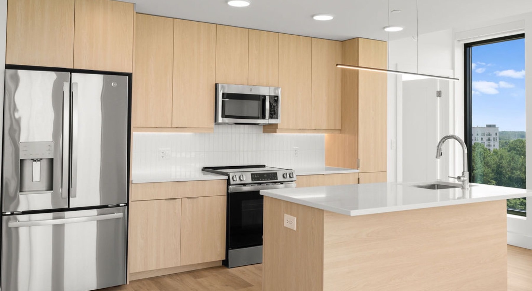 kitchen with stainless steel appliances and an island with white countertops