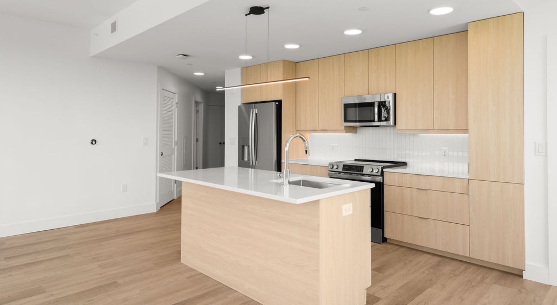 kitchen with stainless steel appliances and an island with white countertops