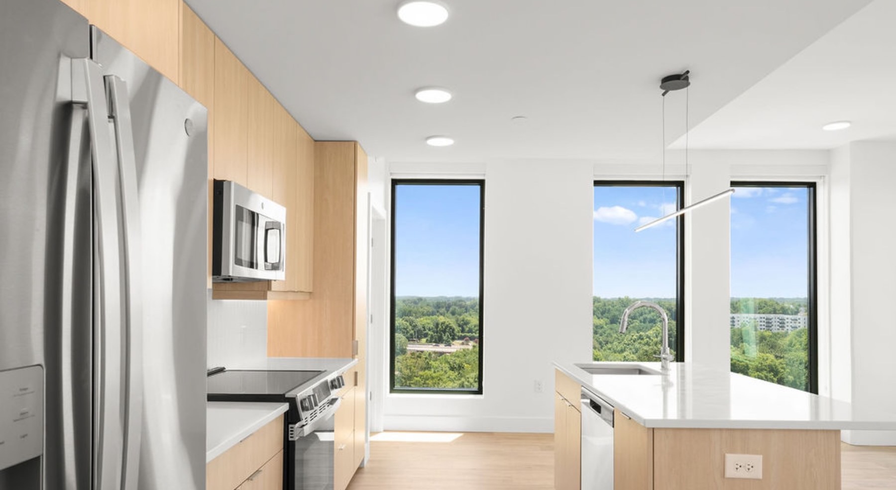 kitchen with stainless steel appliances and an island with white countertops