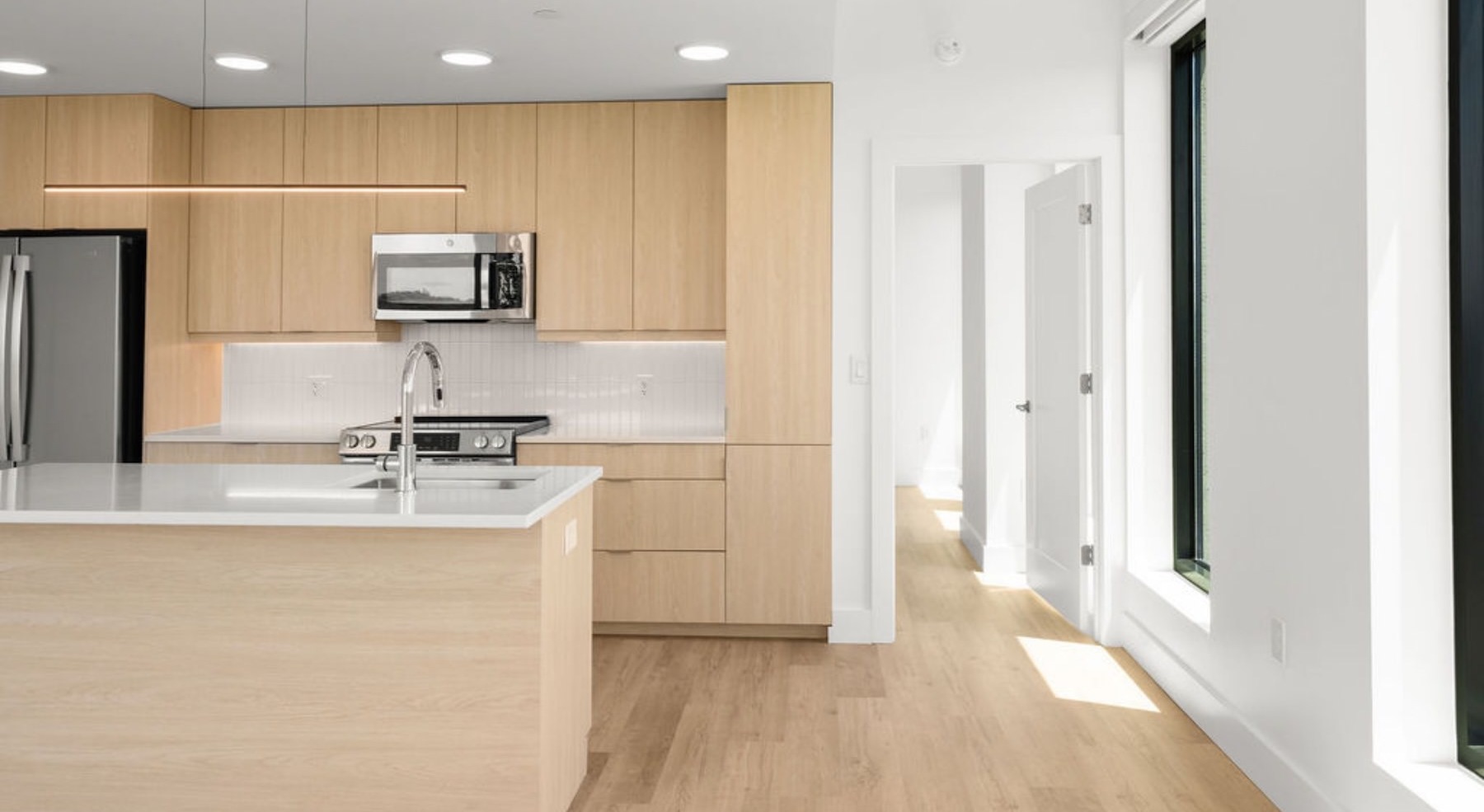 kitchen with stainless steel appliances and an island with white countertops