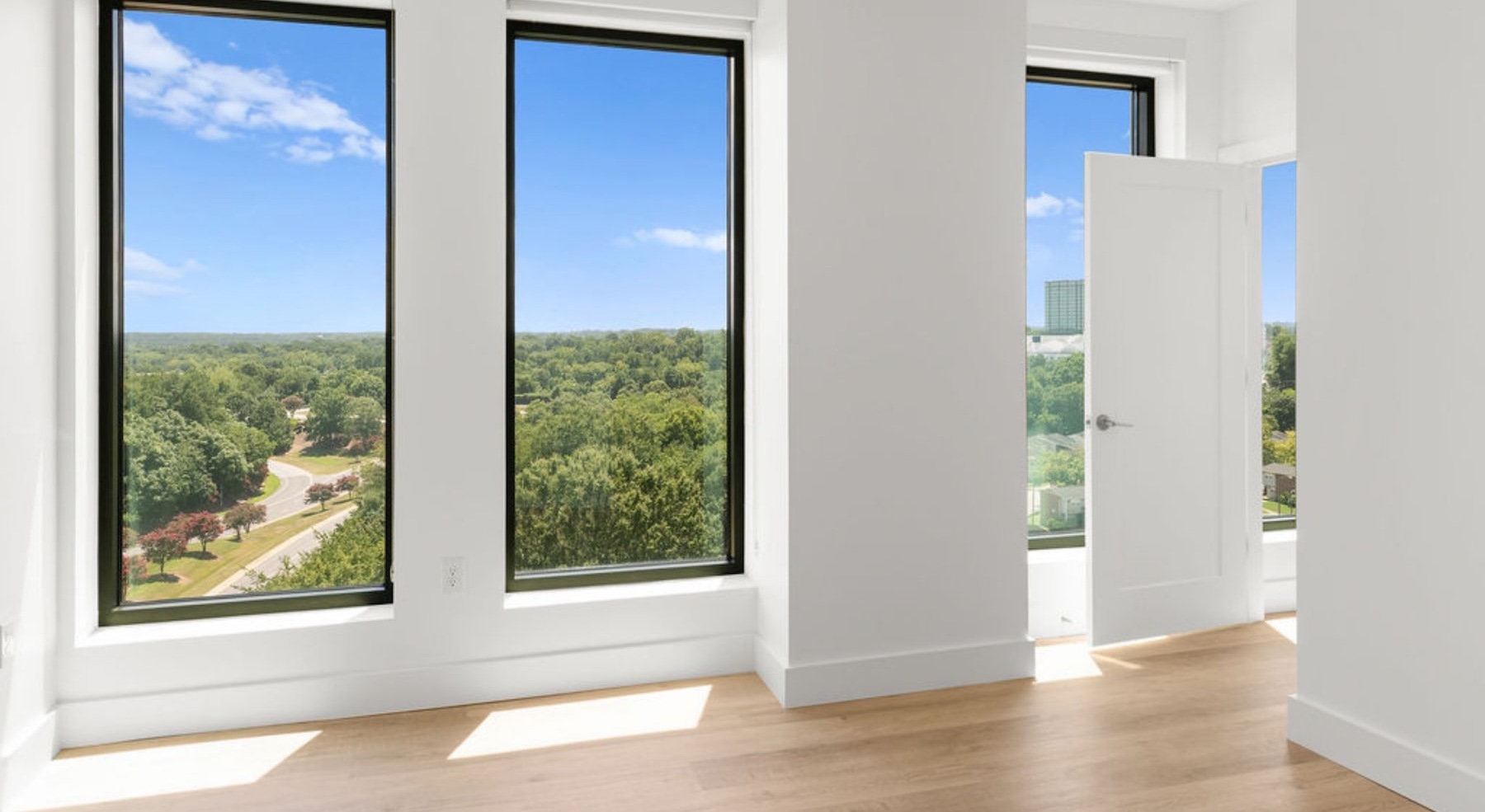 a room with large windows and white walls