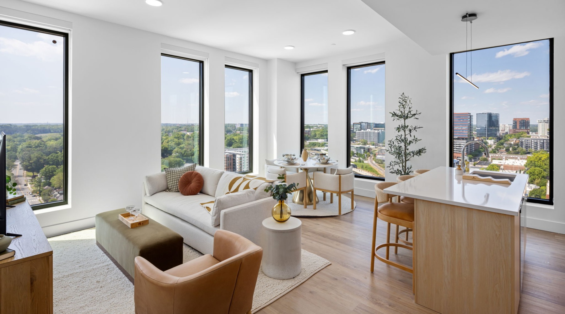 modern living space with floor to ceiling windows and kitchen island