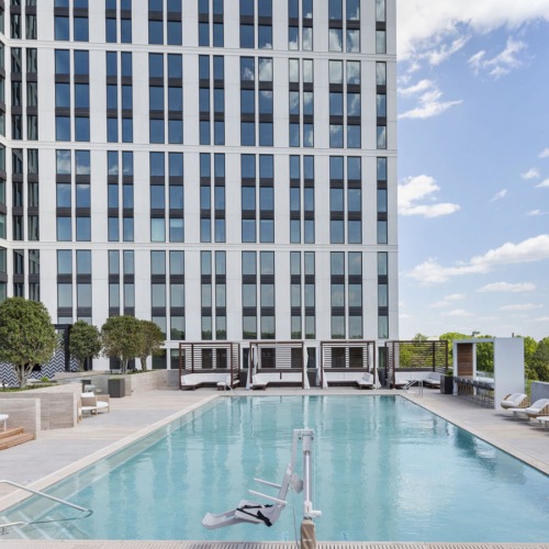 Resort-style pool with lounge seating at Maeve apartments in Raleigh, NC.