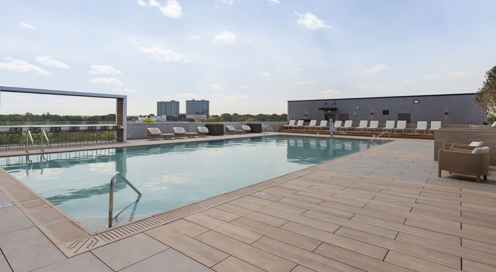 Shimmering resort-style pool Resort-style swimming pool with lounge seating