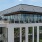 a large white building with a rooftop lounge